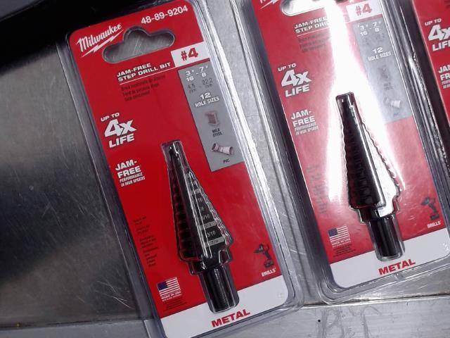 Jam-free step drill bit